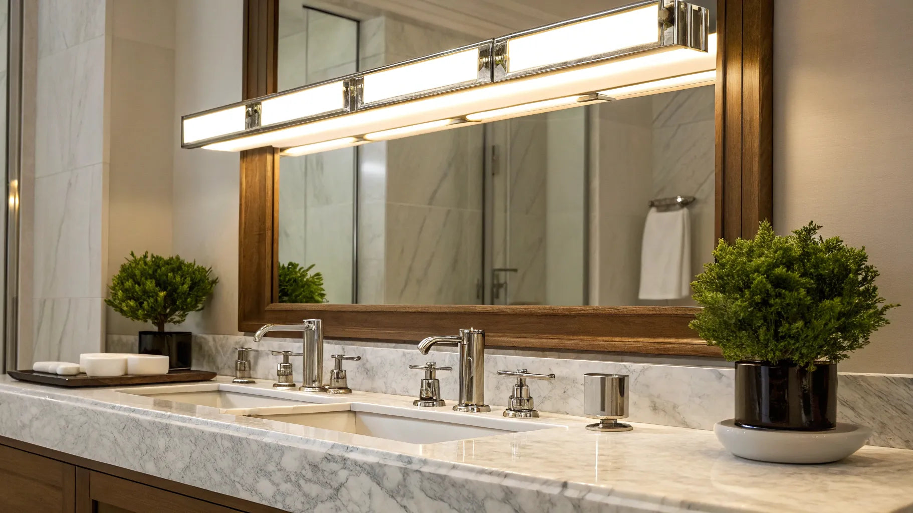 LED vanity lights illuminate a bathroom mirror above a double sink vanity.