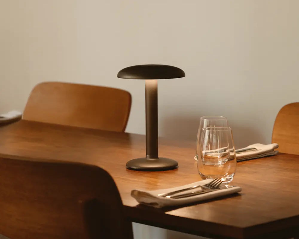 Minimalist dining table with lamp and glassware