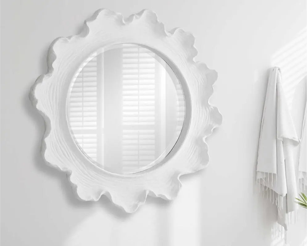 Decorative round mirror with sculpted frame