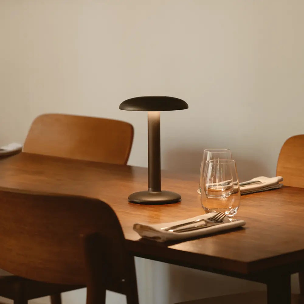 Minimalist dining table with lamp and glassware